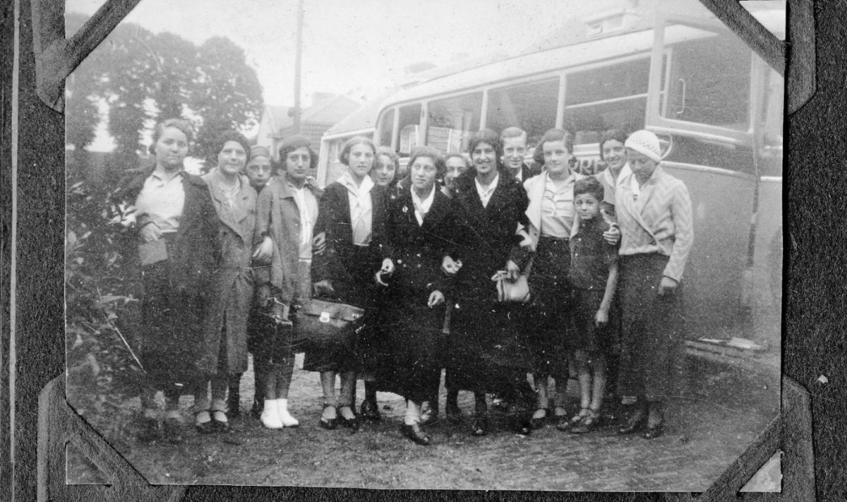 Girls of Huize Dina boarding a bus, from a photo album